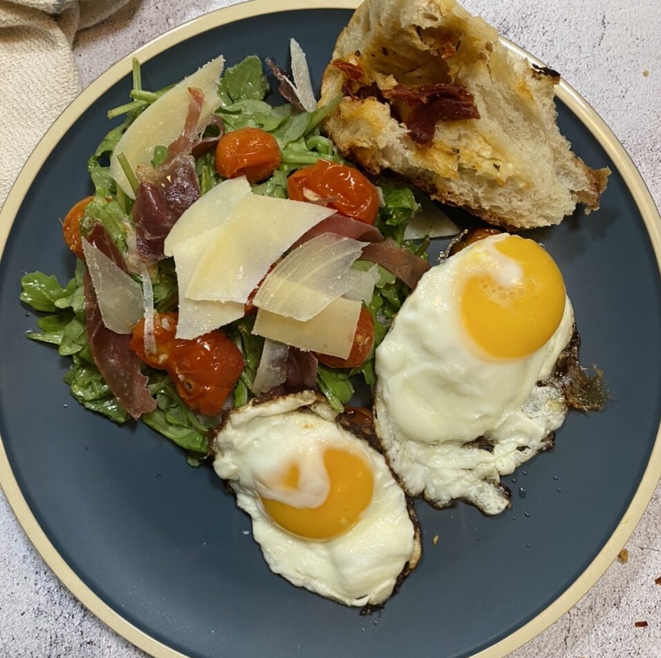 3BBB6541 F481 45BD ACFF 20A0BC70520F e1599750956943 - Zesty Arugula Salad with Prosciutto, Fried Eggs, and Burst Tomatoes in a Lemon Vinaigrette Sauce