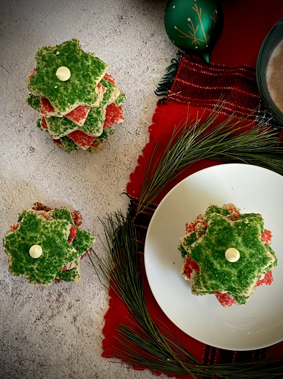 Green and red Christmas sugar cookies on a white plate