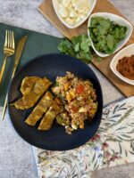 Mediterranean chicken with roasted vegetable farro salad on a blue plate