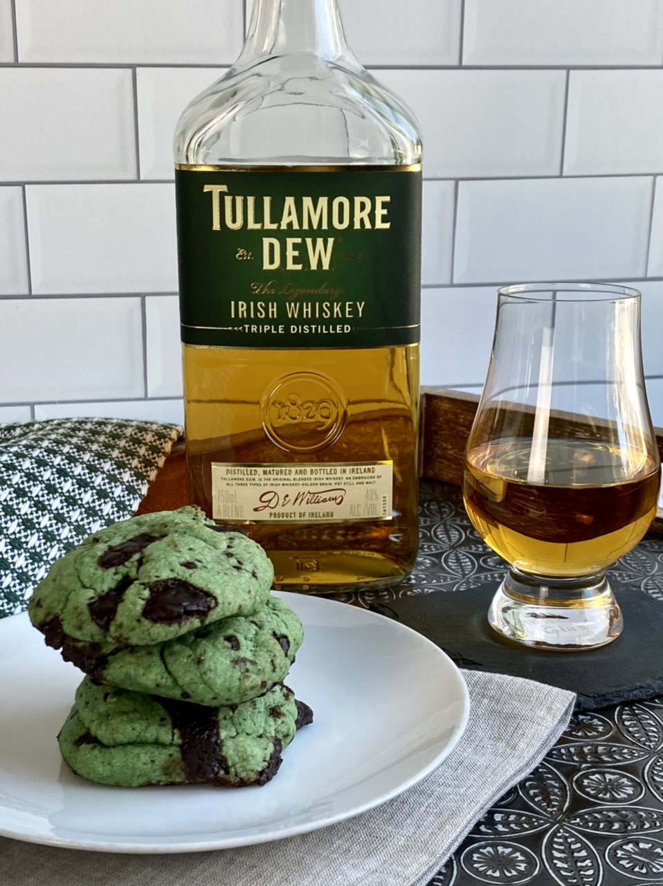 Irish whiskey and chocolate chip cookies on a white plate with tullamore dew whiskey