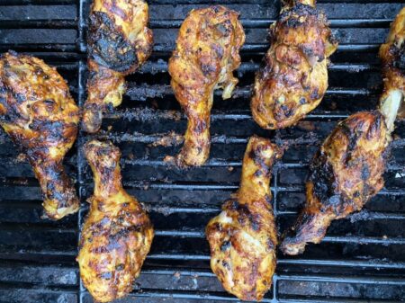 Moroccan grilled chicken drumsticks on a grill
