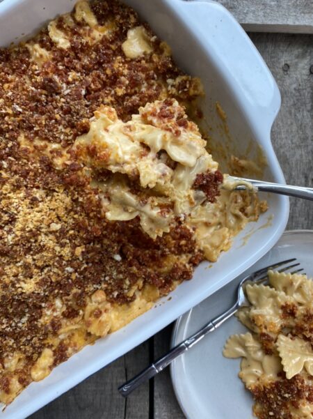 Baked mac and cheese in a casserole dish with chorizo breadcrumbs