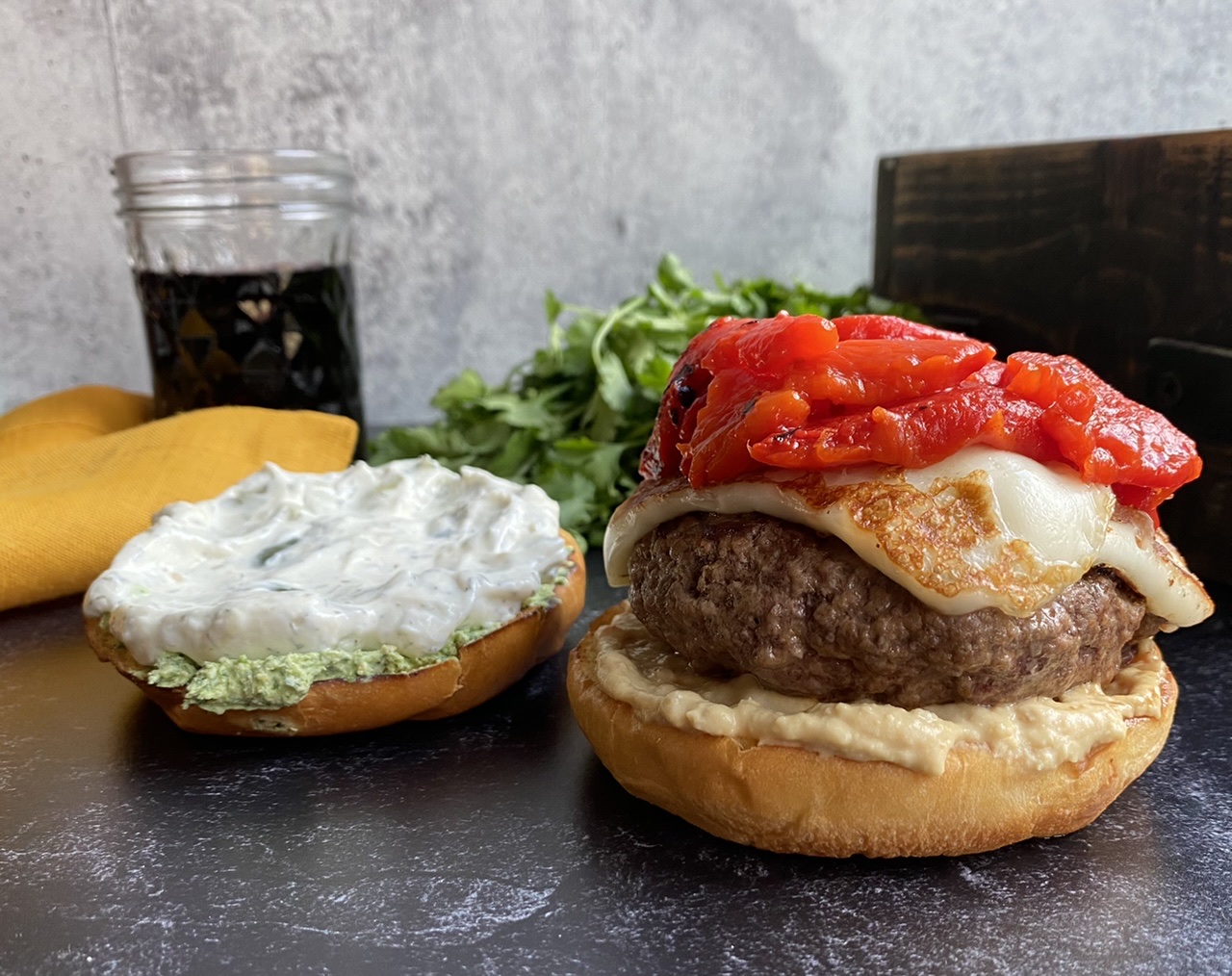 06AC5603 A478 437C 81BC C2E9FC8F5DA4 - Mediterranean Burgers with Fried Halloumi, Roasted Red Peppers, Tzatziki, & Garlic Hummus with a Cilantro Goat Cheese Spread